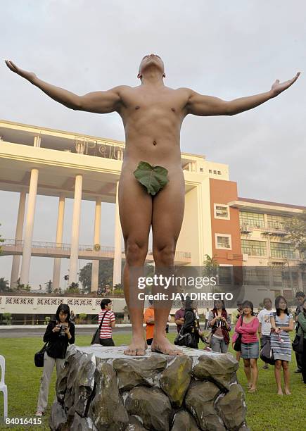 Student and alumni of the country's premier state-run University of the Philippines poses almost naked during the "100 Oblations" in an re-enactement...