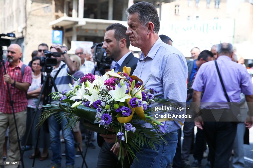 Markale Bosnian man lays a bouquet of flower during the commemoration... News ...