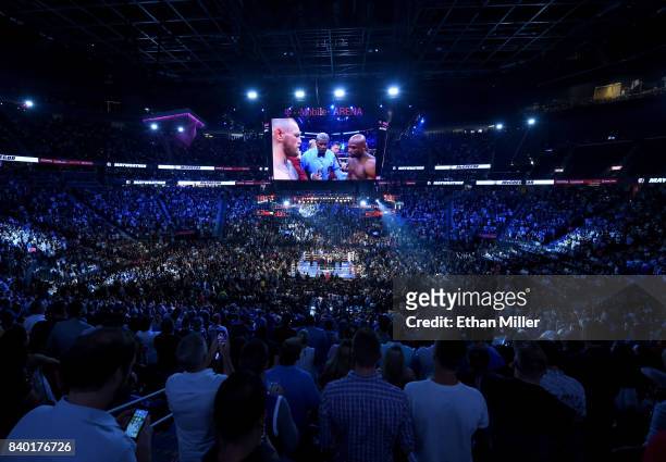 General view shows referee Robert Byrd giving instructions to Floyd Mayweather Jr. And Conor McGregor before their super welterweight boxing match on...