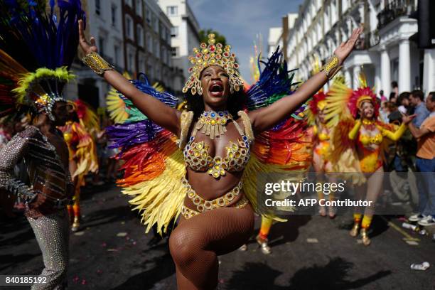 Carnival performers participate in the parade on the main day of the Notting Hill Carnival in west London on August 28, 2017. Nearly one million...