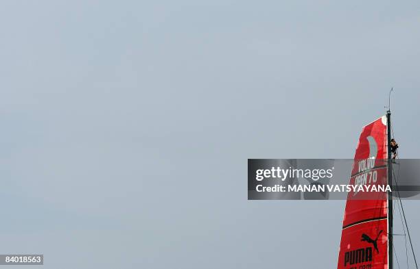 Media crewmember on board the Puma Ocean race yacht is seen perched on top of a sail during a ceremonial parade prior to the start of the Volvo Ocean...