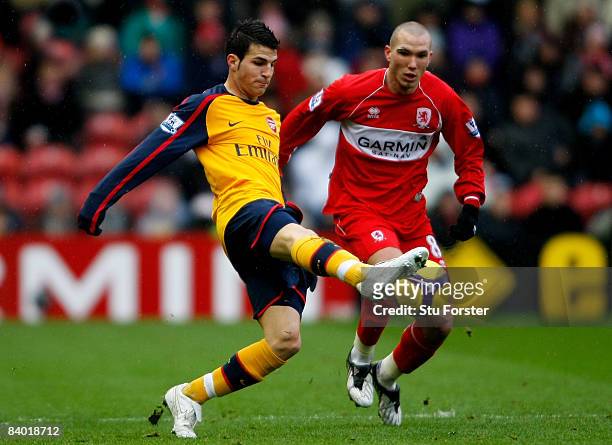 Arsenal player Cesc Fabregas gets to the ball ahead of Middlesbrough player Didier Digard during the Barclays Premier League match between...