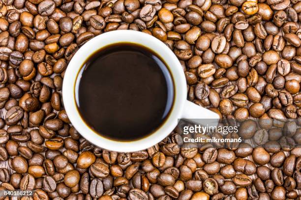 cup coffee with coffee beans - bean stock-fotos und bilder