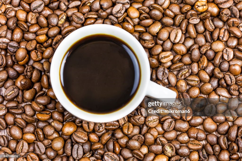 Cup coffee with coffee beans