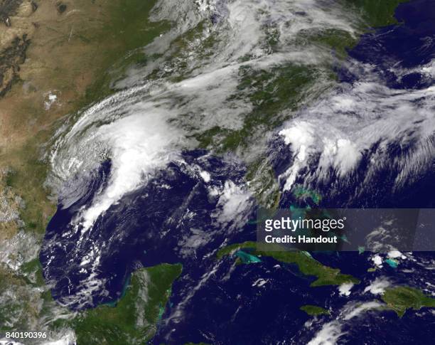 In this NOAA handout image, NOAA's GOES East satellite capture of Tropical Storm Harvey as it churns 13:45 UTC on August 28, 2017 on the mid-Texas...