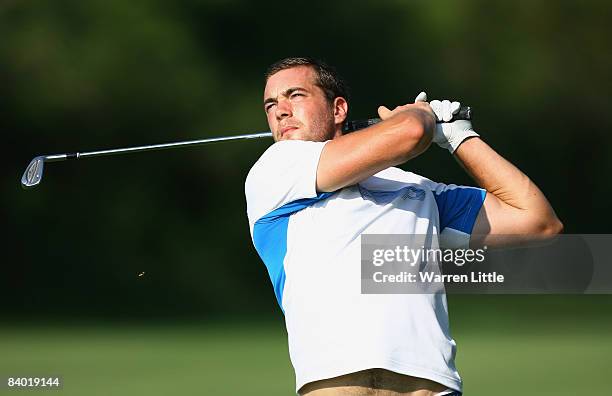 Oskar Henningsson of Sweden plays his second shot into the 16th green during the third round of the Alfred Dunhill Championship at Leopard Creek...