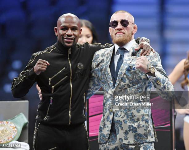 Floyd Mayweather Jr. And Conor McGregor pose for pictures during a news conference after Mayweather's 10th-round TKO victory in their super...