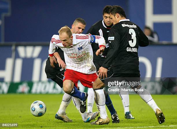 David Jarolim of Hamburg and Benjamin Koehler and Aaron Galindo of Frankfurt battle for the ball during the Bundesliga match between Hamburger SV and...