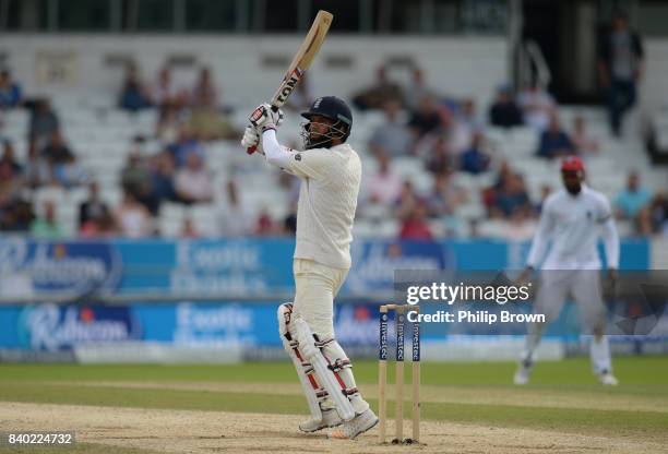 Moeen Ali of England hits a four during the fourth day of the 2nd Investec Test match between England and the West Indies at Headingley cricket...