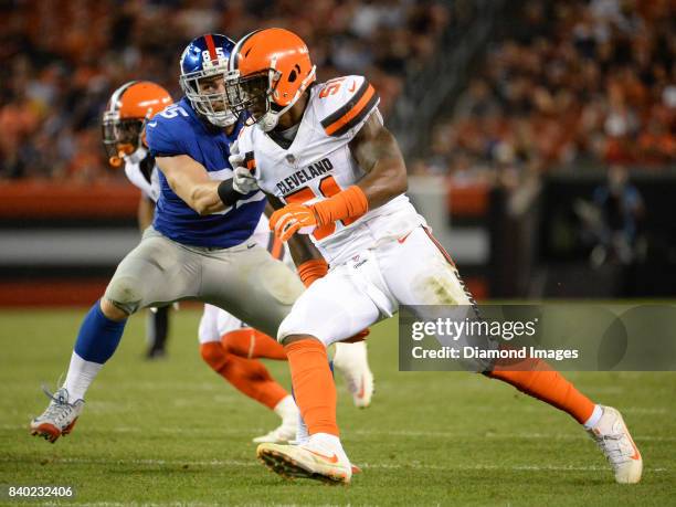 Linebacker Jamie Collins Sr. #51 of the Cleveland Browns rushes around the block of tight end Rhett Ellison of the New York Giants in the second...