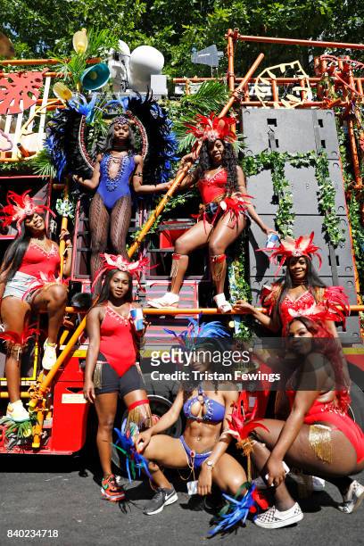 Dancers pose in front of the Red Bull Music Academy x Mangrove float at Notting Hill Carnival on August 28, 2017 in London, England.