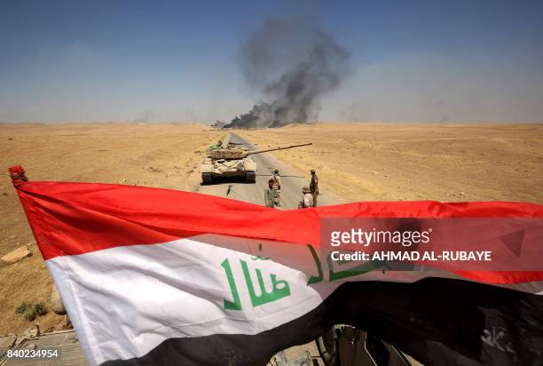 Smoke billows from the village of al-Ayadieh, near Qubuq, north of Tal Afar, as Iraqi forces advance during the ongoing operation to retake the area...