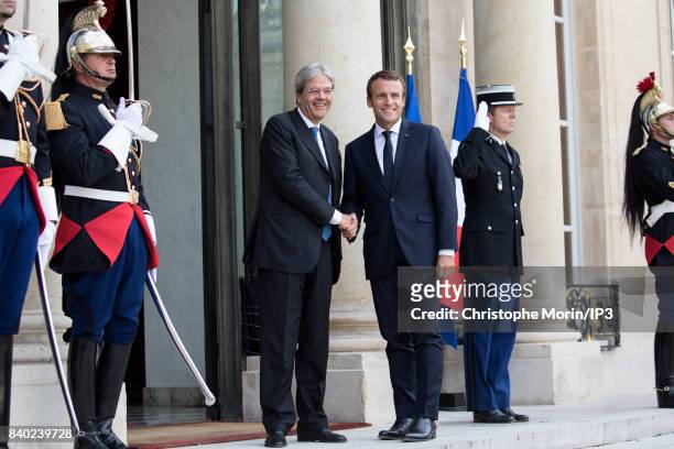 French President Emmanuel Macron welcomes President of the Italian Council Paolo Gentiloni at the Elysee Palace on August 28, 2017 in Paris, France....