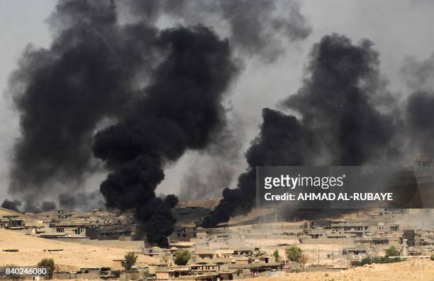Smoke billows from the village of al-Ayadieh, near Qubuq, north of Tal Afar, as Iraqi forces advance during the ongoing operation to retake the area...