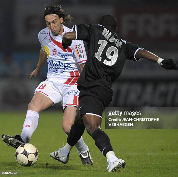 Nancy's defender Frederic Biancalani vies with Grenoble's forward Franck Dja Djedje during the French L1 football match Nancy vs Grenoble on December...