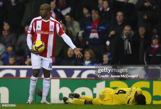 Ricardo Fuller of Stoke looks on as John Pansil of Fulham falls to the ground holding his face during the Barclays Premier League match between Stoke...