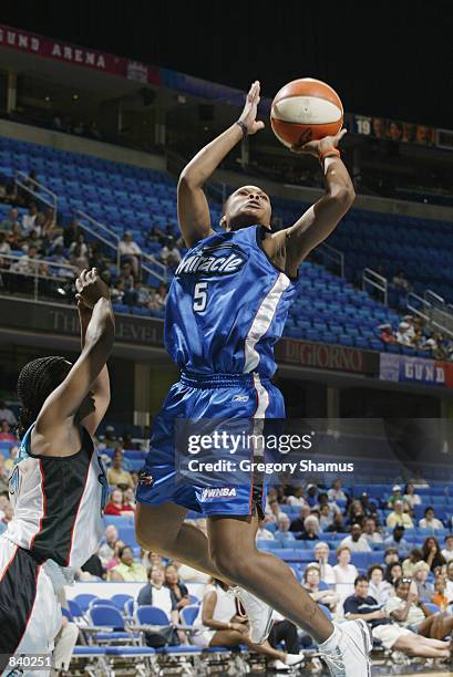 Elaine Powell of the Orlando Miracle puts a shot up in the game against the Cleveland Rockers on June 19, 2002 at Gund Arena in Cleveland, Ohio. The...