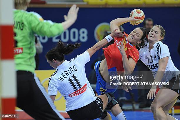 Spain's Macarena Aguilar shoots to the Germany's goal defended by Germany's goalkeeper Clara Woltering , Germany's Mandy Hering and Germany's Anna...