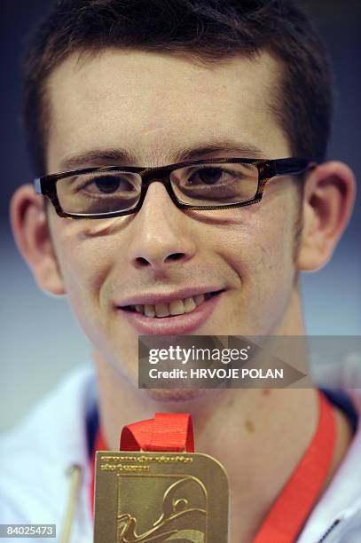 Federico Colbertaldo of Italy shows his gold medal after winning the men's 1500m freestyle final race during the European Short Course Swimming...