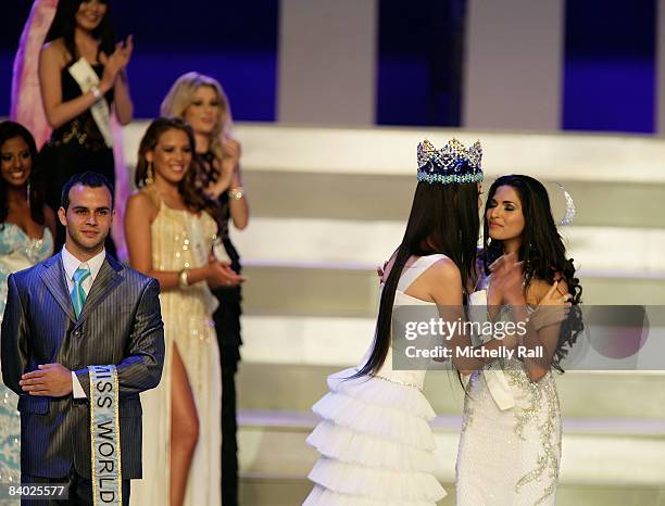Miss World 2007 titleholder Zhang Zi of China embraces 2008 contestant, Miss India Parvathy Omanakuttan on stage during the 58th Miss World 2008...