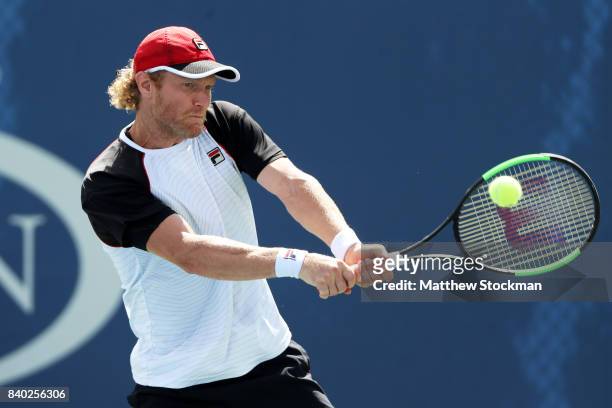 Dmitry Tursunov of Russia returns a shot during his first round Men's Singles match against Cameron Norrie of the United Kingdom on Day One of the...