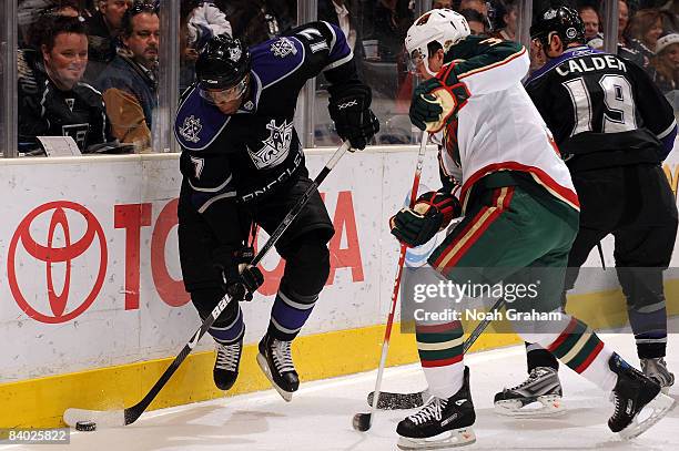 Marek Zidlicky of the Minnesota Wild fights for the puck alongside the boards as Wayne Simmonds of the Los Angeles Kings controls the puck on...