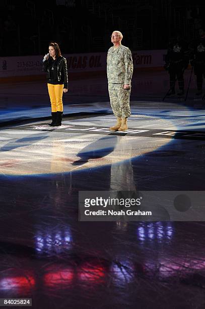 Military her,o US Army Chaplin Colonel William L. Brunold is honored during the singing of the National Anthem prior to the game between the...