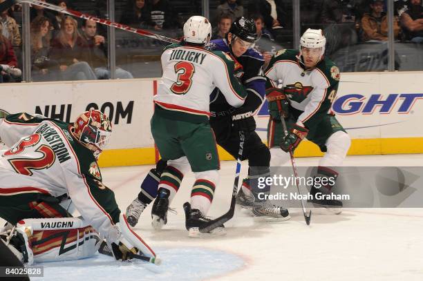 Niklas Backstrom, Marek Zidlicky and Martin Skoula of the Minnesota Wild defend in the crease as Patrick O'Sullivan of the Los Angeles Kings battles...