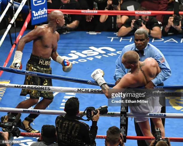 Floyd Mayweather Jr. Reacts as referee Robert Byrd stops his super welterweight boxing match against Conor McGregor to give Mayweather a 10th-round...
