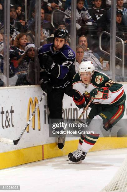 Antti Miettinen of the Minnesota Wild checks Kyle Quincey of the Los Angeles Kings into the boards on December 13, 2008 at Staples Center in Los...