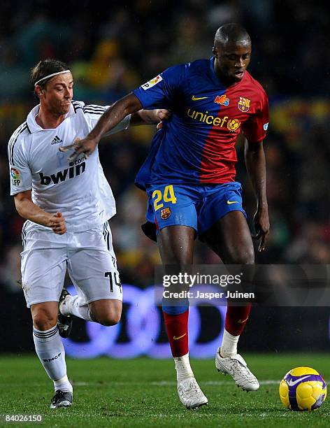 Yaya Toure of Barcelona duels for the ball with Jose Maria Gutierrez of Real Madrid during the La Liga match between Barcelona and Real Madrid at the...