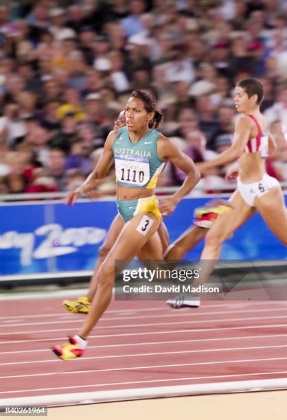 Cathy Freeman of Australia runs a first round heat of the Women's 400 meters event of the 2000 Summer Olympics track and field competition on...