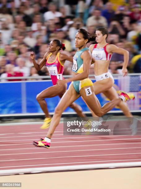 Cathy Freeman of Australia runs a first round heat of the Women's 400 meters event of the 2000 Summer Olympics track and field competition on...