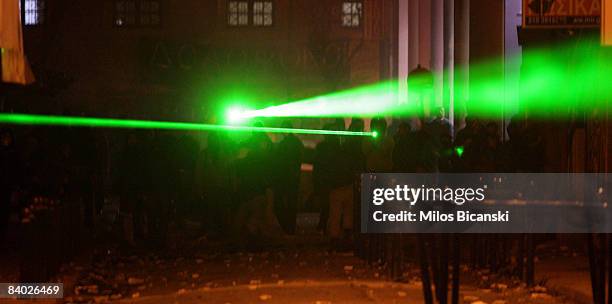 Laser light pointer is pointed outside Athens Polytechnic during riots on December 13, 2008 in Athens, Greece. Small bands of Greek rioters hurling...