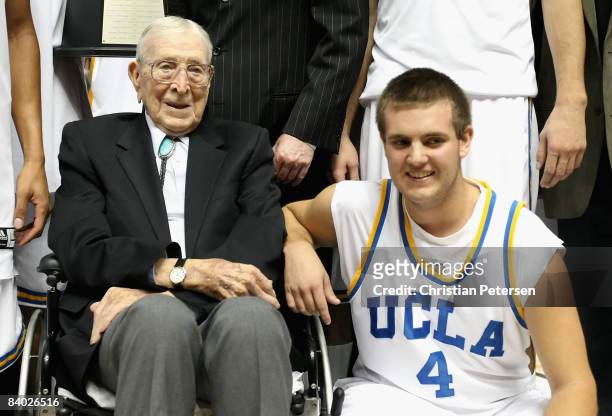 Former coach John Wooden poses with great grandson Tyler Trapani of the UCLA Bruins after the John R. Wooden Classic game against the DePaul Blue...