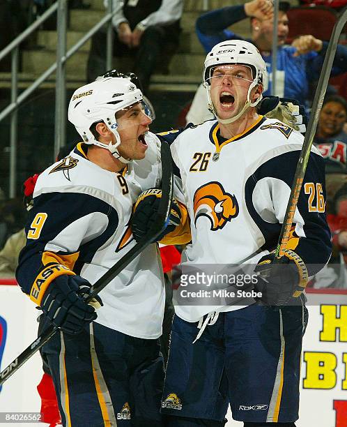 Thomas Vanek of the Buffalo Sabres celebrates his third period goal and 10,000 in team history with teammate Derek Roy against the New Jersey Devils...