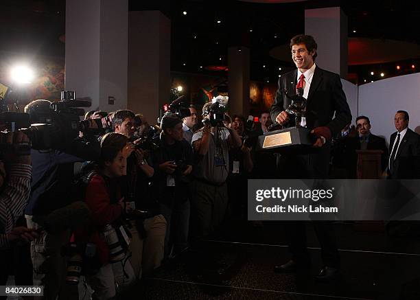 Sam Bradford of the Oklahoma Sooners holds the Heisman Trophy on December 13, 2008 at the Sports Museum of America in New York City.