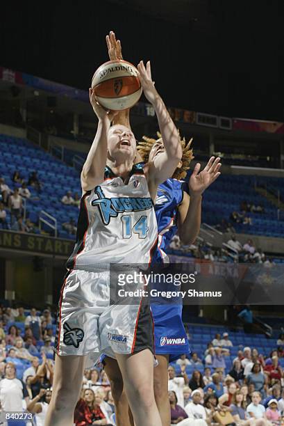 Penny Taylor of the Cleveland Rockers goes to the basket past Nykesha Sales of the Orlando Miracle in the game on June 19, 2002 at Gund Arena in...