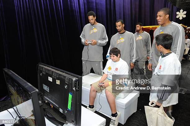 Members of the Los Angeles D-Fenders play video games with participants at the 2008 Los Angeles Lakers holiday party at Toyota Sports Center on...
