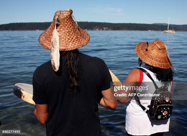 Stanch tribal member Paul Cheoketen Wagner and Yaskam/Nez Perce tribal member Roxanne White take part in ceremony at edge of Salish Sea, on the same...