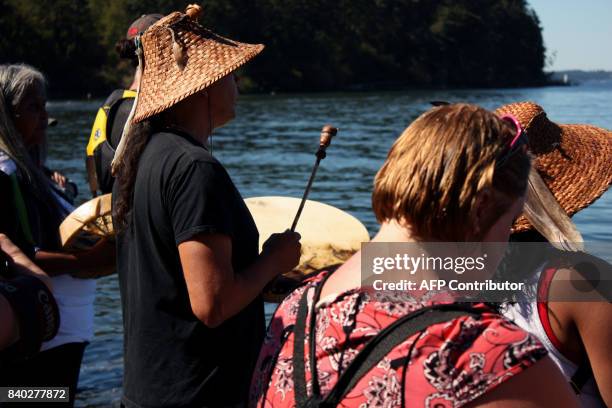 Stanch tribal member Paul Cheoketen Wagner takes part in a ceremony at edge of Salish Sea, on the same day they participated in a water-based...