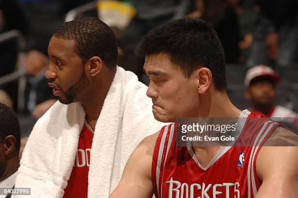 Tracy McGrady and Yao Ming of the Houston Rockets look on from the bench during their game against the Los Angeles Clippers at Staples Center on...