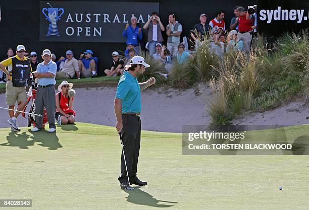 Tim Clark of South Africa watches Mathew Goggin of Australia miss a two-metre putt for par to lose the playoff for the Australian Open title at the...