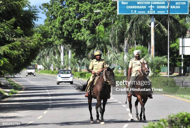 Security personnel march during pronouncement of the sentence against the Dera Sacha Sauda cult chief Gurmeet Ram Rahim Singh in dual rape case on...