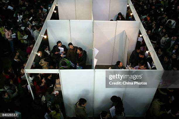 Job seekers join the crowd at a job fair for postgraduate students on December 14, 2008 in Beijing, China. Nearly 40,000 applicants competed for...