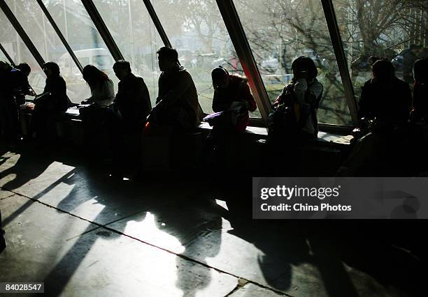 Job seekers rest at a job fair for postgraduates on December 14, 2008 in Beijing, China. Nearly 40,000 applicants competed for approximately 14,228...