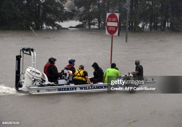 Sheriff's boat rescues people after Hurricane Harvey caused heavy flooding in Houston, Texas on August 28, 2017. Rescue teams in boats, trucks and...