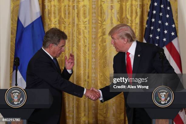 President Donald Trump and President Sauli Niinisto of Finland shake hands during a joint news conference at the East Room of the White House August...