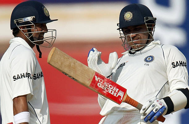 Indian cricketer Gautam Gambhir watches as teammate Virender Sehwag enacts a shot during the fourth day of the first Test match between India and...