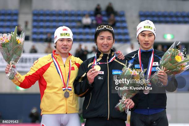 Silver medalist Yu Fengtong of China, gold medalist Yuya Oikawa of Japan and bronze medalist Lee Kang-seok of South Korea pose for photographers on...